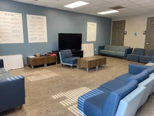 Blue couch in room with tv and blue painted wall