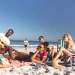 Group of friends on beach having a picnic