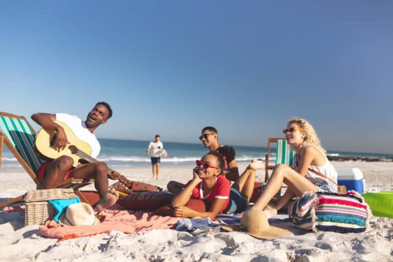 Group of friends on beach having a picnic
