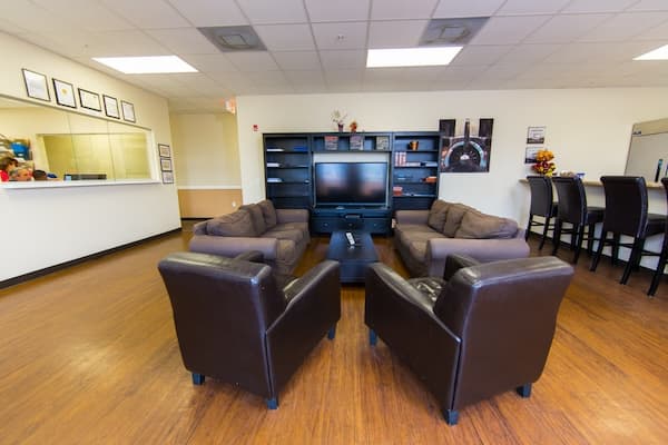 Common area with hardwood floors and a seating area in front of a television